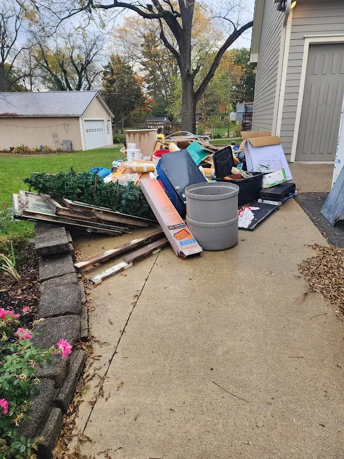 Dumpster being loaded with debris for Roofing Dumpster Rental in Sallisaw